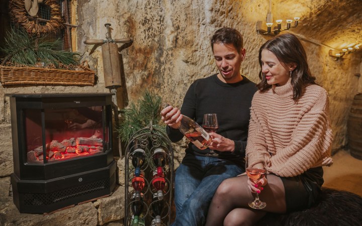 Young couple drinks wine at Christmas