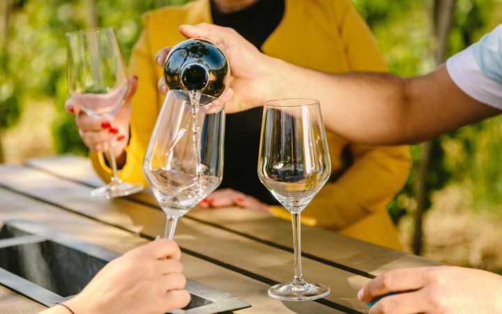 Wine poured into glass at a wine tasting